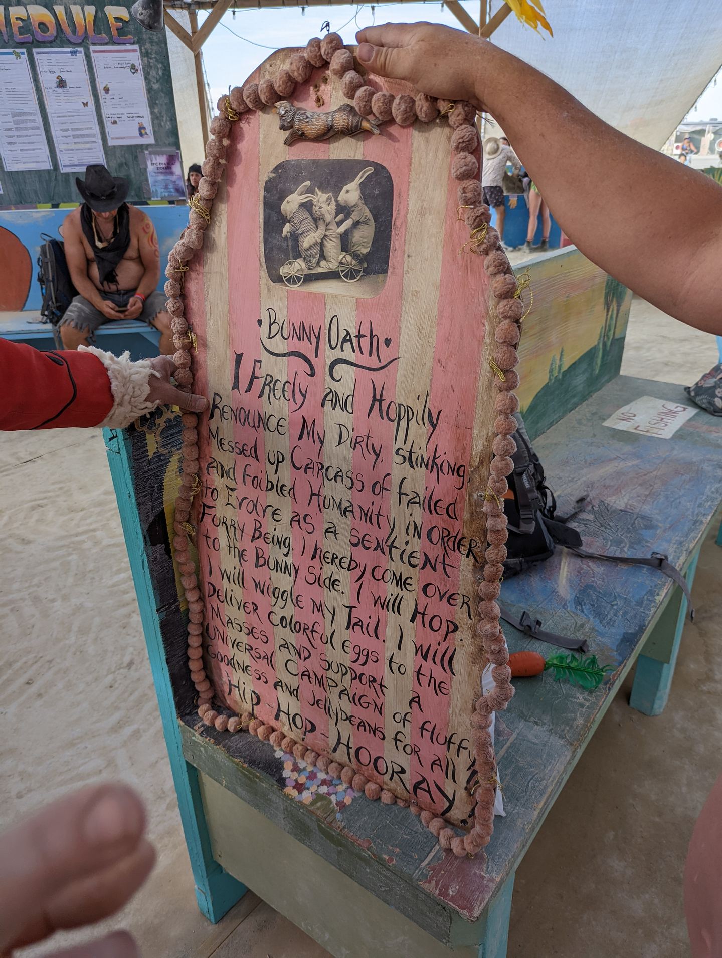 A hand painted Bunny Oath sign held up in the desert